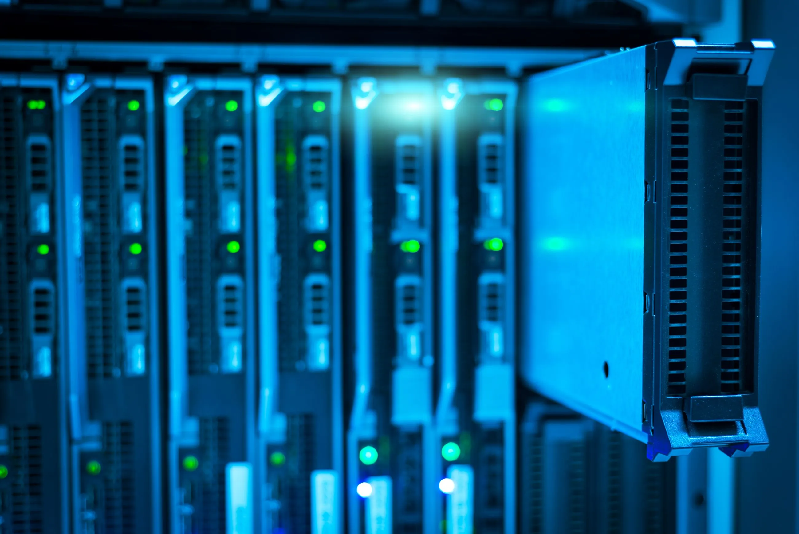 Blade servers with status lights, one module pulled out of the chassis